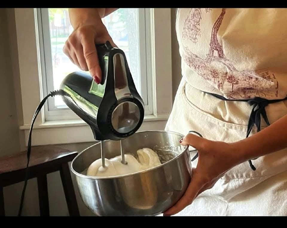 Sandrine mixing ingredients in a stainless-steel bowl